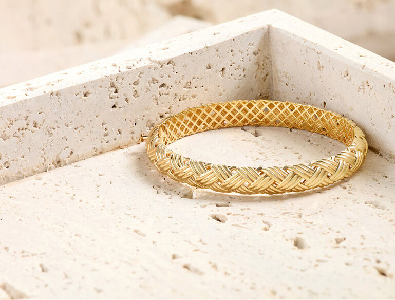 Gold bangle bracelet with woven texture